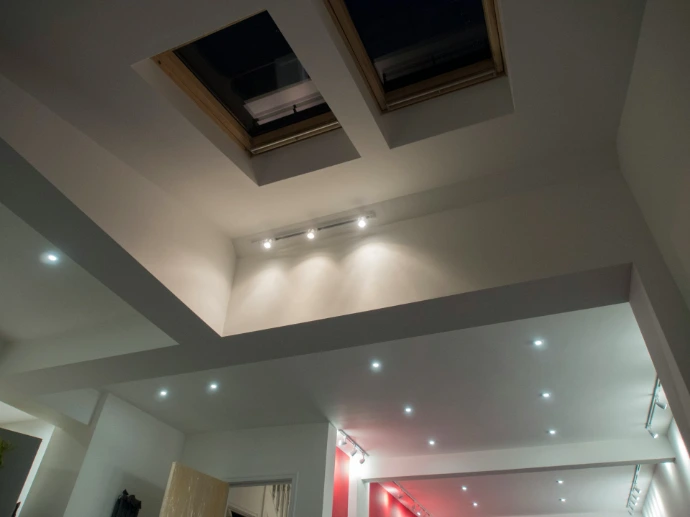 Skylights and recessed lighting in a modern ceiling.